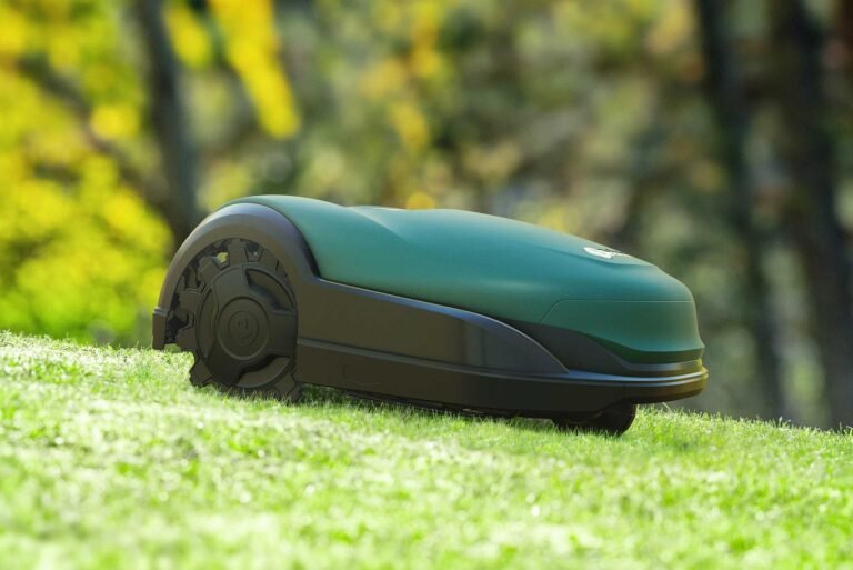 Robotic mower operating on wet grass in light rain